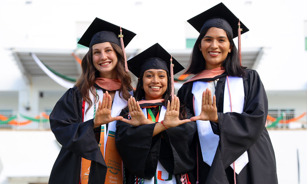 Group of graduates doing the U sign