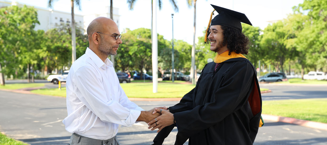 Alumni shaking hands with professor