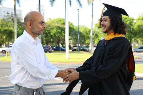 Alumni shaking hands with professor