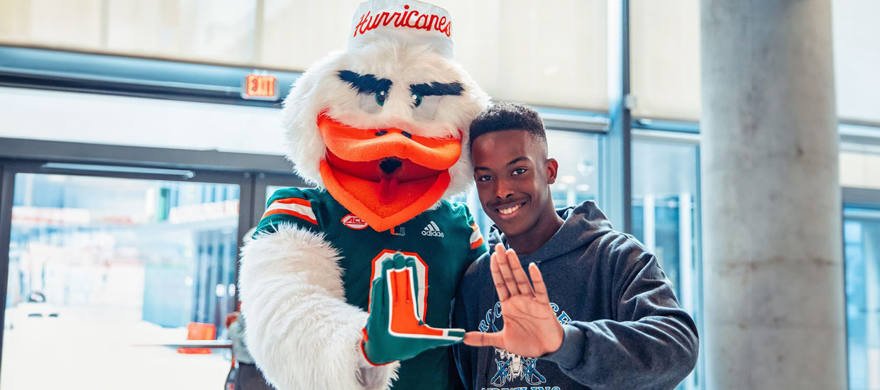 Ibis with student making the U sign with their hands