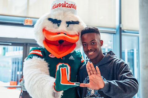 Ibis with student making the U sign with their hands