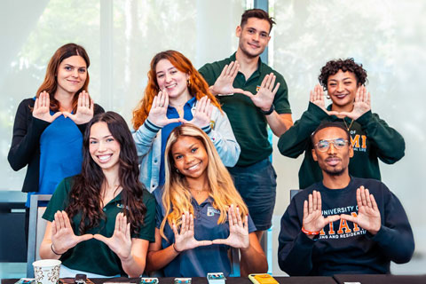 Group of students doing the "U" gesture